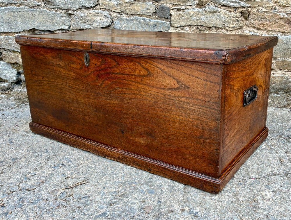 A rectangular antique elm blanket box featuring a hinged lid, visible wood grain, and a central keyhole escutcheon. View VIII