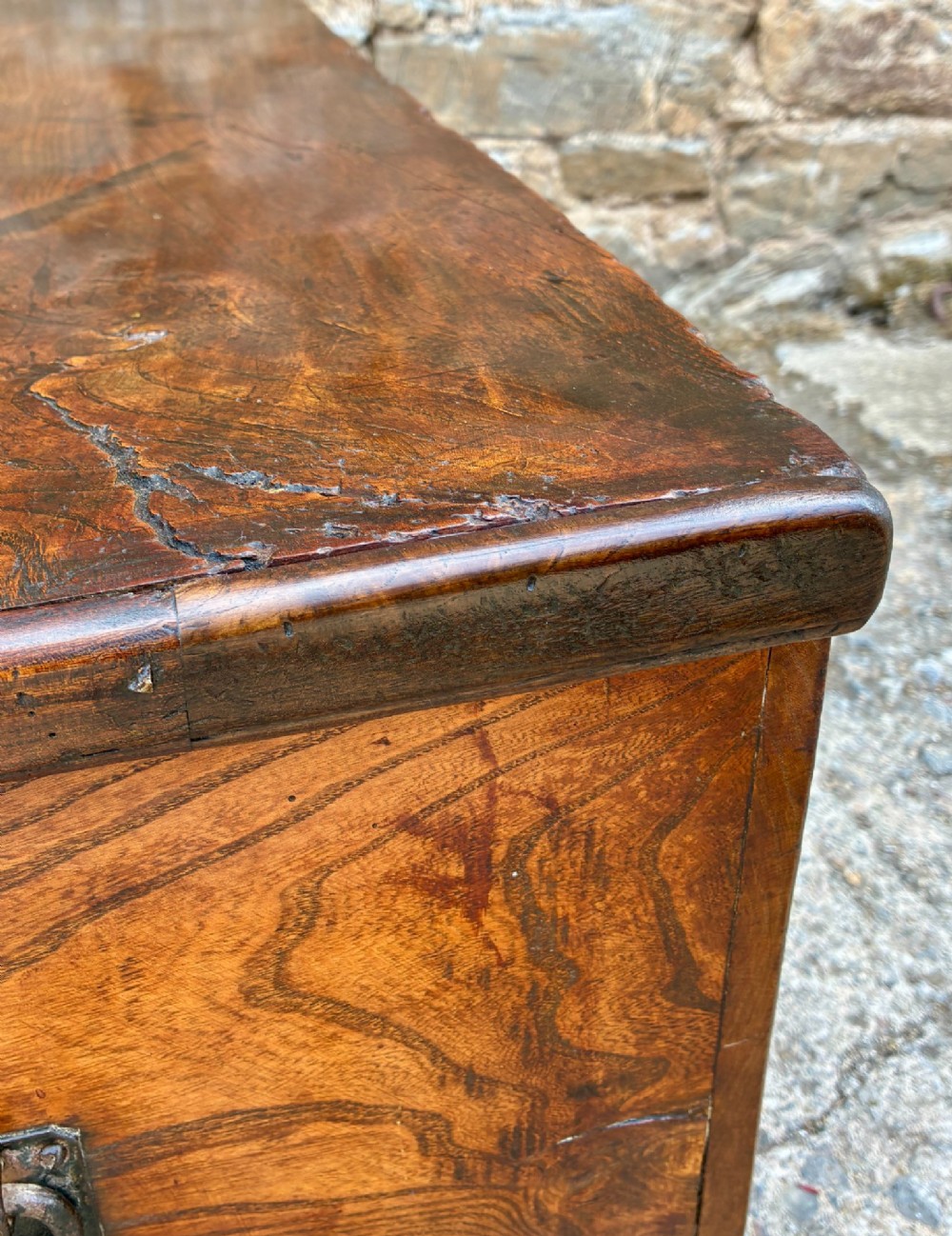 A rectangular antique elm blanket box featuring a hinged lid, visible wood grain, and a central keyhole escutcheon. View X