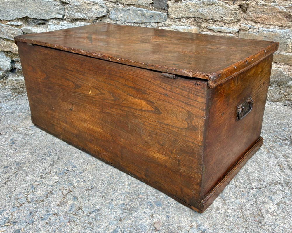 A rectangular antique elm blanket box featuring a hinged lid, visible wood grain, and a central keyhole escutcheon. View XIV