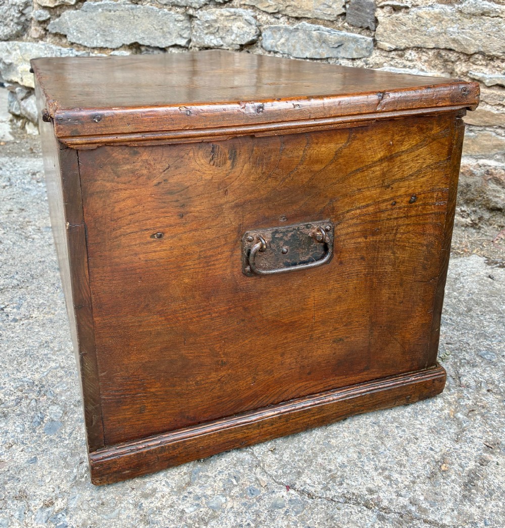 A rectangular antique elm blanket box featuring a hinged lid, visible wood grain, and a central keyhole escutcheon. View XV