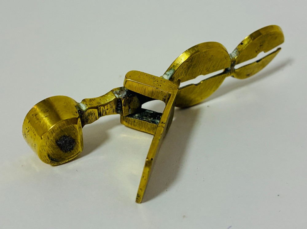 A Victorian brass rocker scale designed for testing gold sovereign coins against a plain white background. View VI