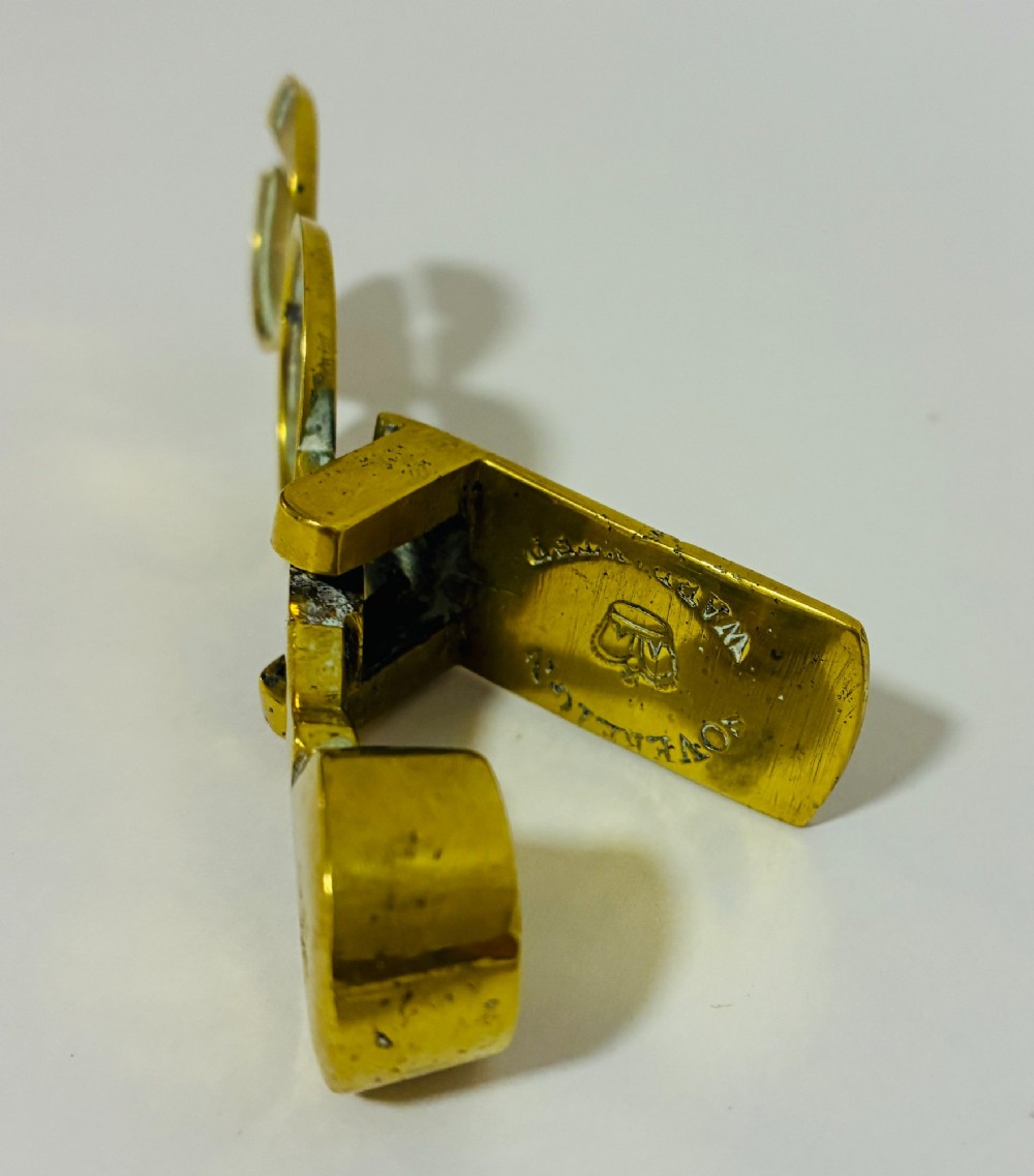 A Victorian brass rocker scale designed for testing gold sovereign coins against a plain white background. View VII
