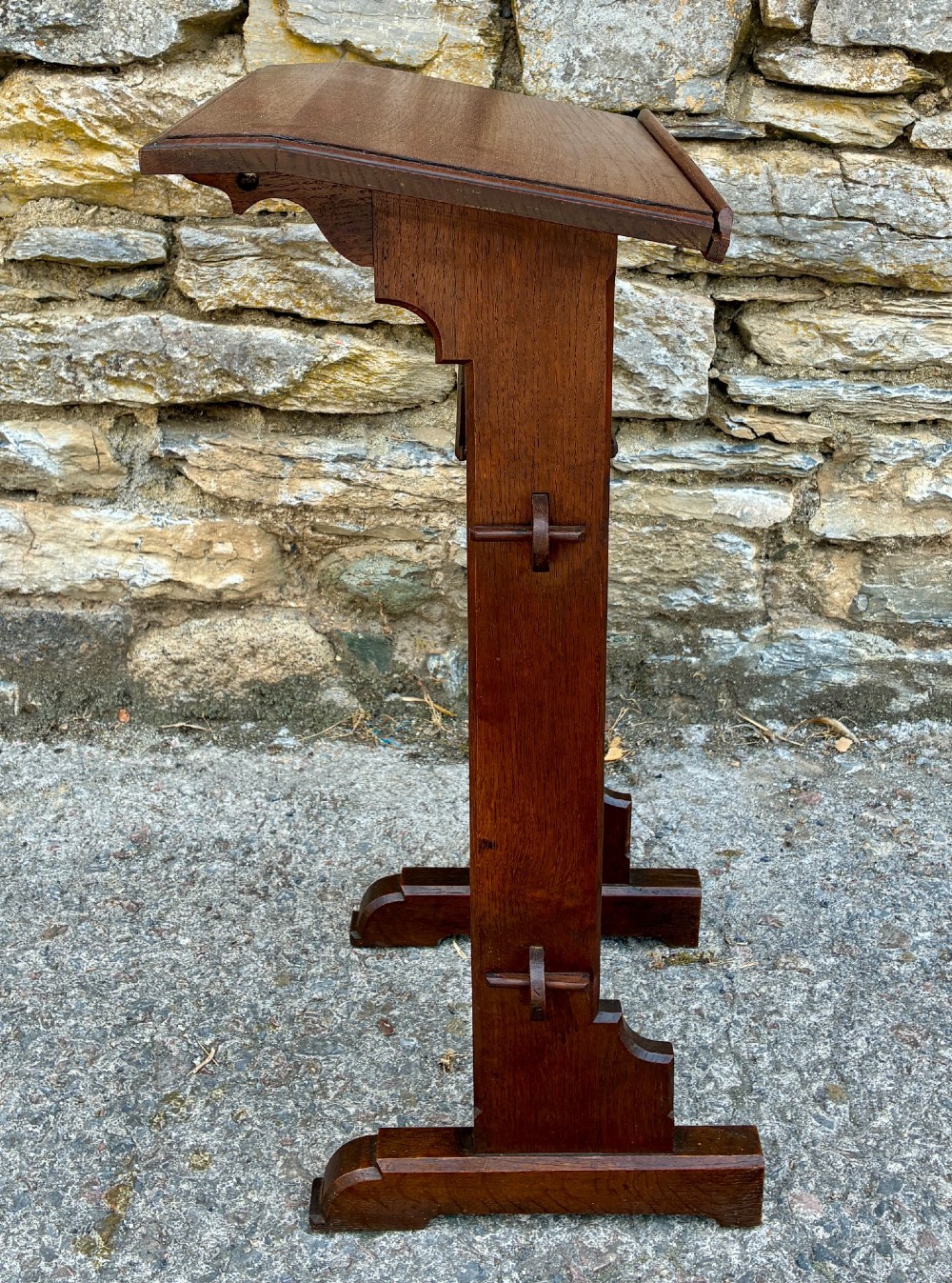 A small antique dark oak church lectern featuring a slanted reading top, trefoil cutouts, and a trestle base. View VI