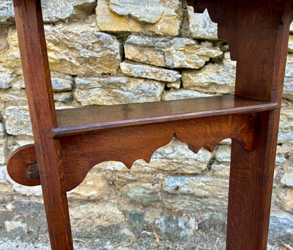 A small antique dark oak church lectern featuring a slanted reading top, trefoil cutouts, and a trestle base. View X