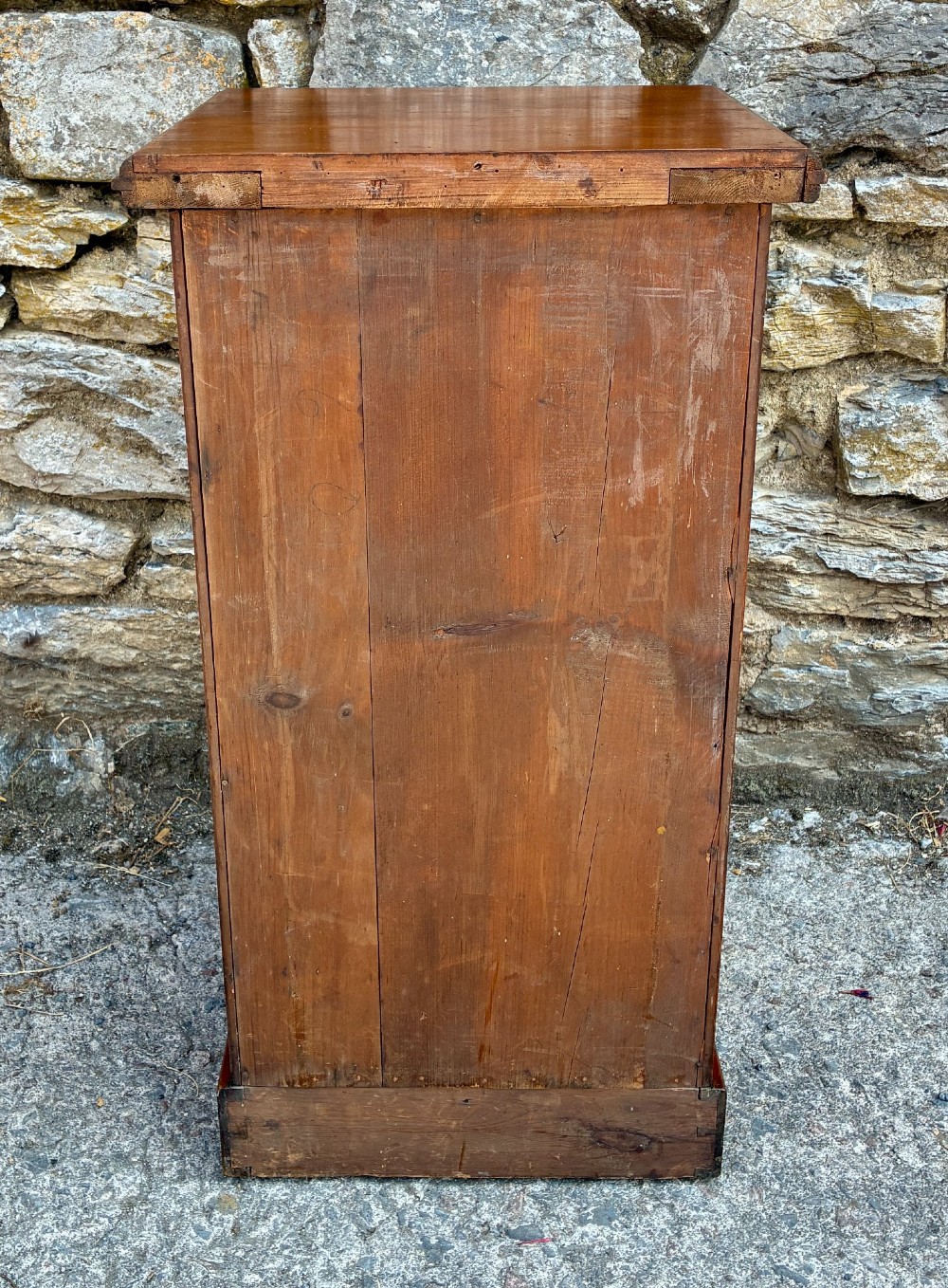 An Edwardian warm brown walnut pot cupboard featuring a single panelled door with a brass handle and reeded side moulding. View IX