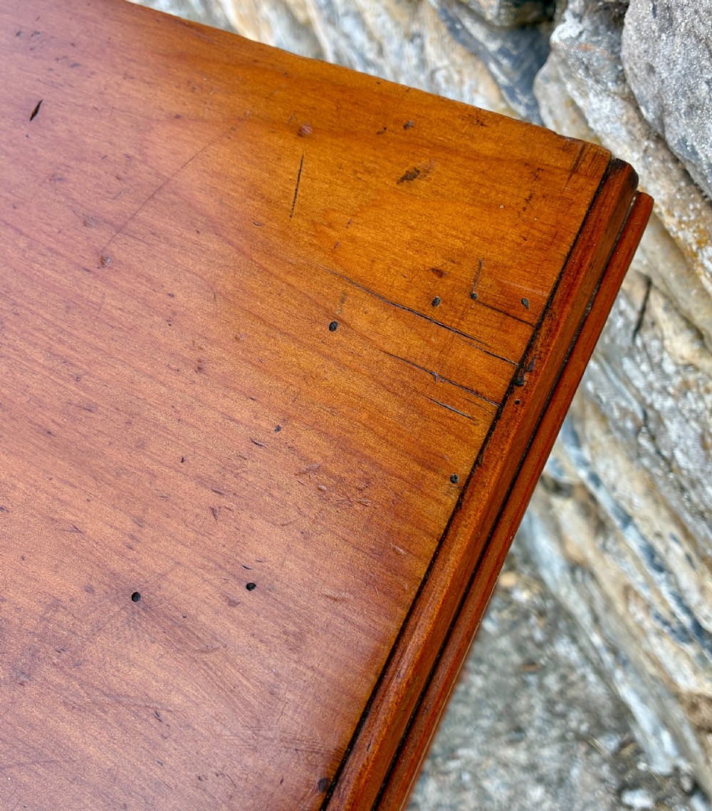 An Edwardian warm brown walnut pot cupboard featuring a single panelled door with a brass handle and reeded side moulding. View XII