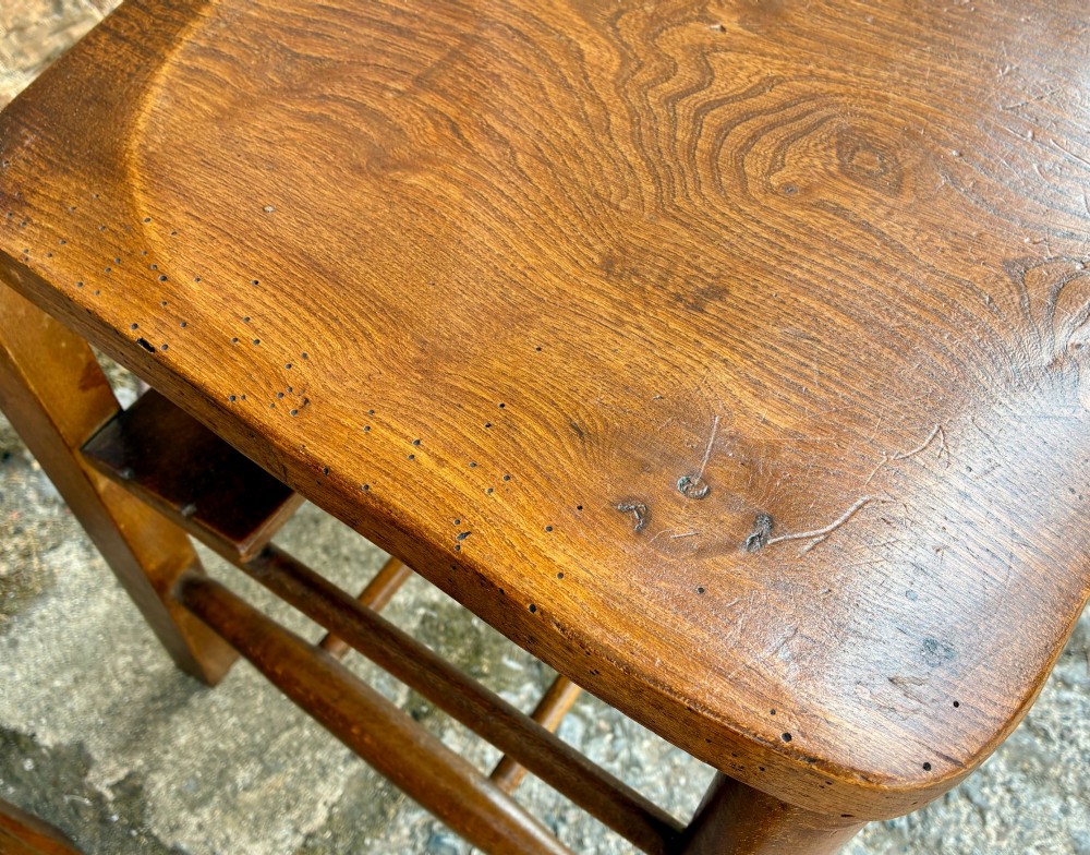 A set of four matching antique wooden chapel chairs with contoured seats and ladder-back rails. View XIV