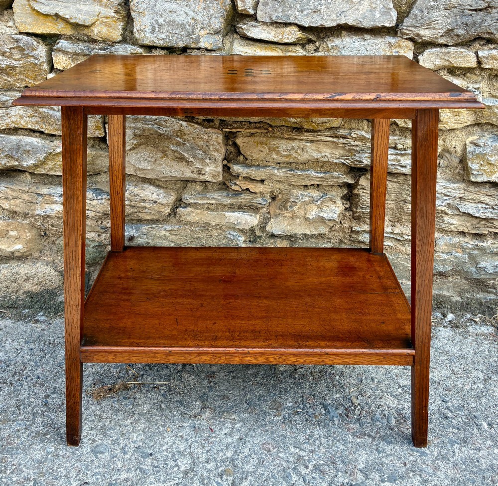 An Arts and Crafts solid oak side table featuring a lower shelf, straight square legs, and dark circular wood inlays arranged in a grid pattern on the top surface. View II