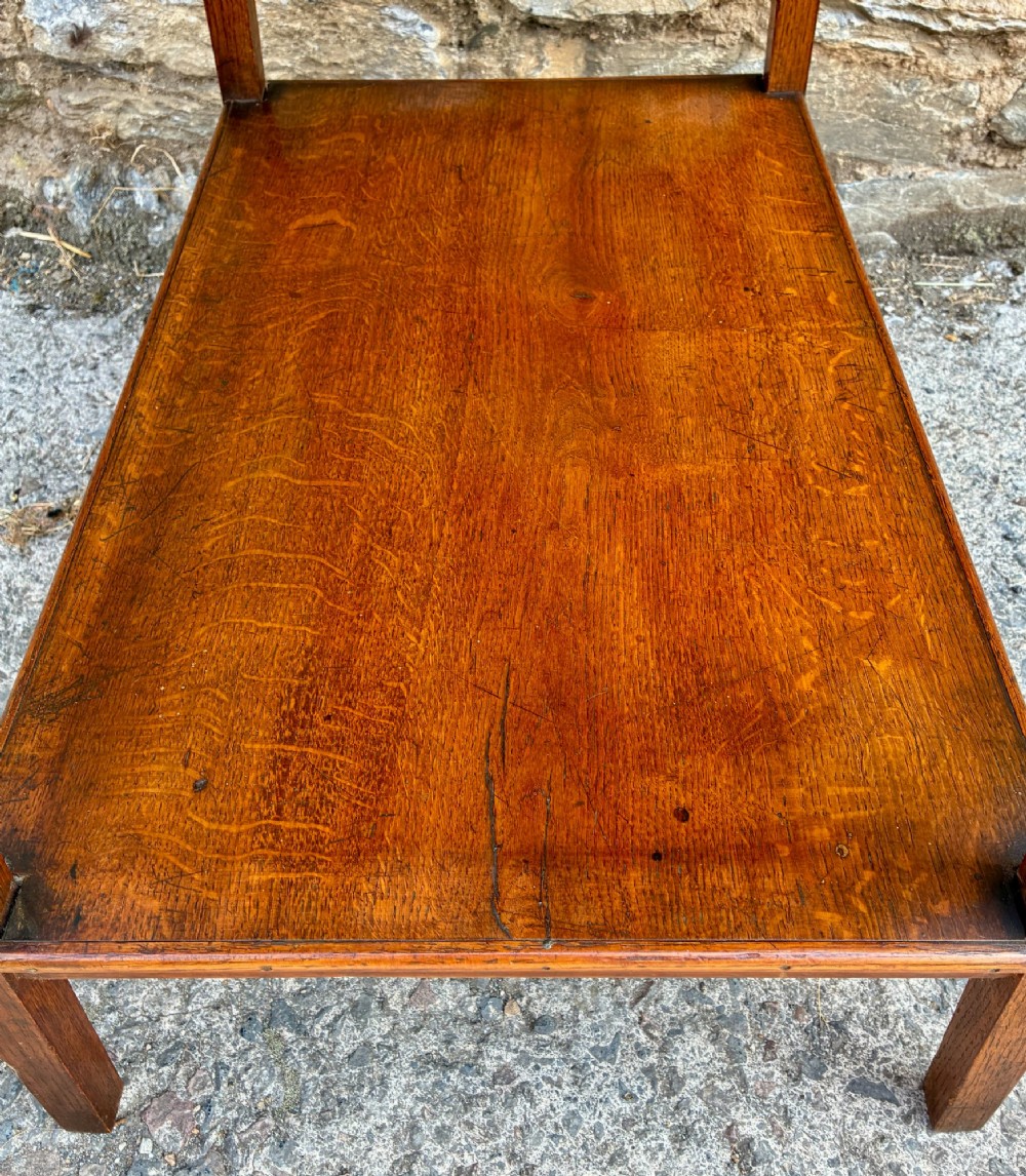 An Arts and Crafts solid oak side table featuring a lower shelf, straight square legs, and dark circular wood inlays arranged in a grid pattern on the top surface. View VIII