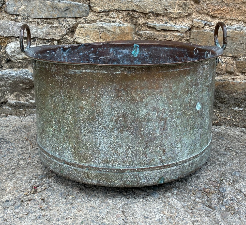 A large cylindrical antique copper wash tub featuring a flared rolled rim, side handles, and a heavily aged green verdigris patina. View II