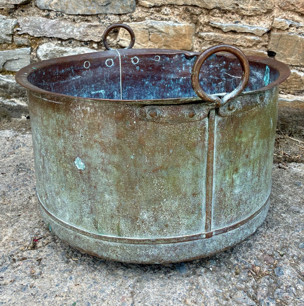 A large cylindrical antique copper wash tub featuring a flared rolled rim, side handles, and a heavily aged green verdigris patina. View IV
