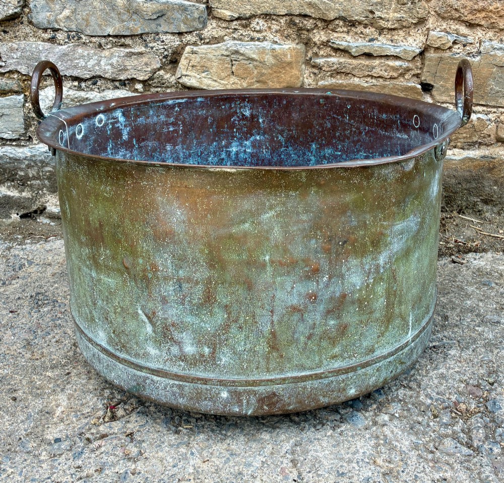 A large cylindrical antique copper wash tub featuring a flared rolled rim, side handles, and a heavily aged green verdigris patina. View VII