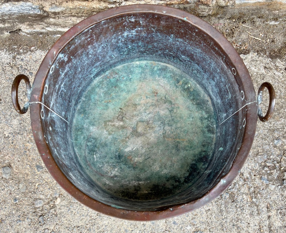 A large cylindrical antique copper wash tub featuring a flared rolled rim, side handles, and a heavily aged green verdigris patina. View VIII