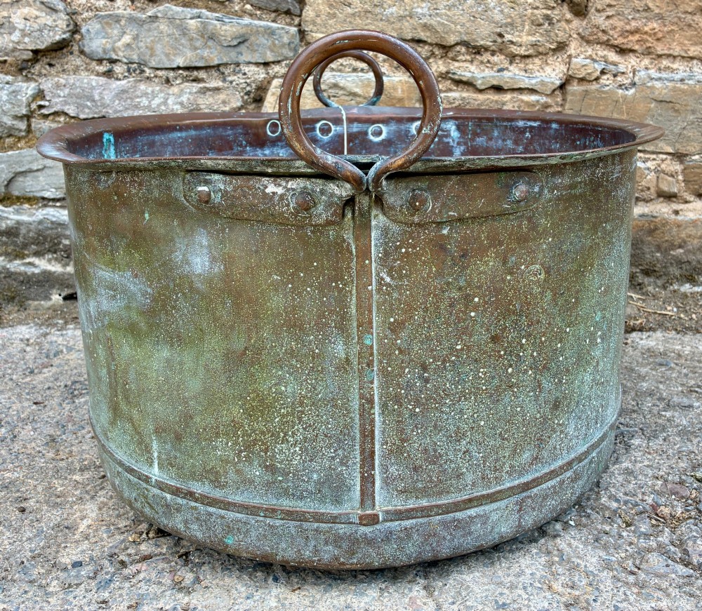 A large cylindrical antique copper wash tub featuring a flared rolled rim, side handles, and a heavily aged green verdigris patina. View IX