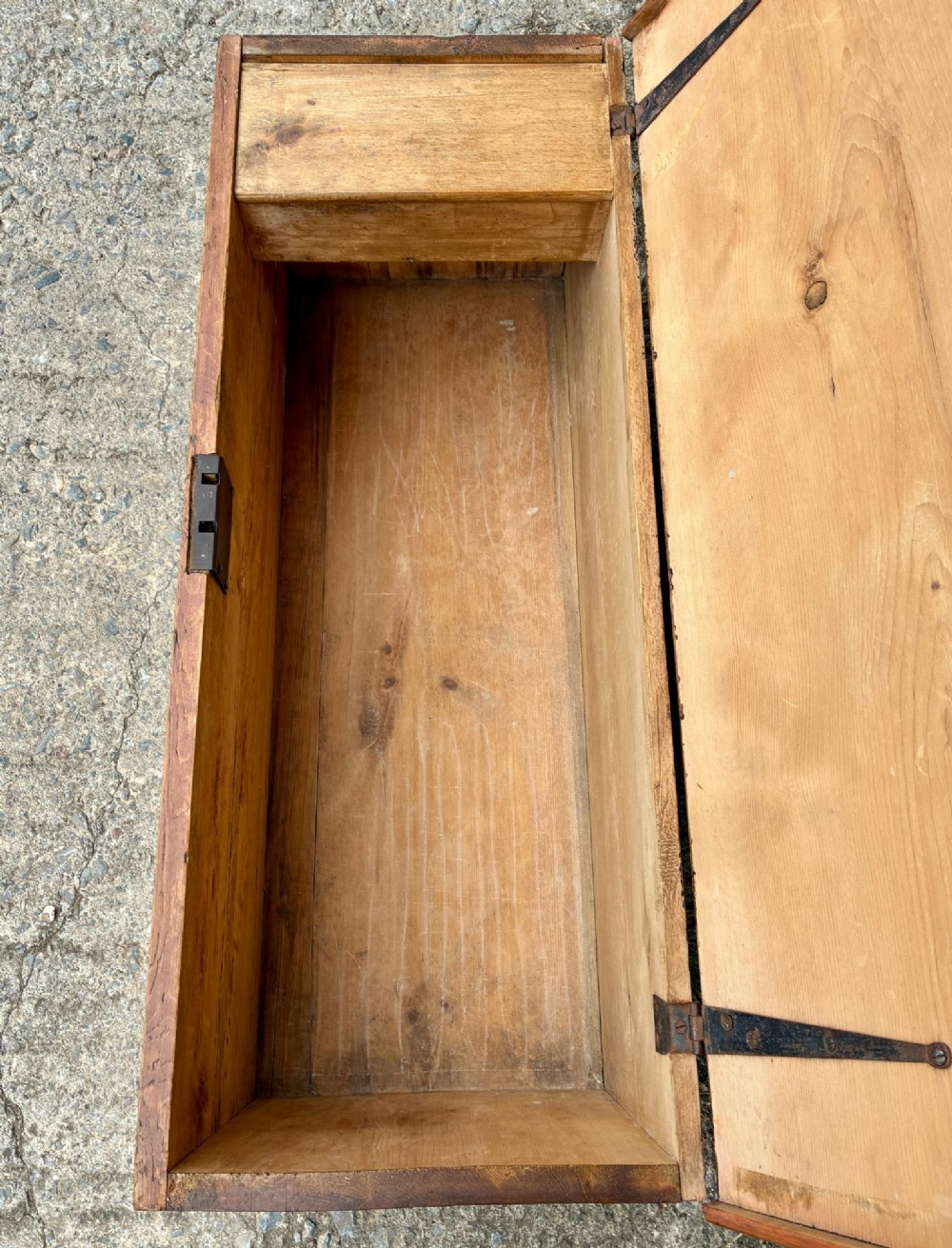 A rectangular pine blanket box featuring a hinged lid, brass keyhole escutcheon, and a low plinth base. View VI