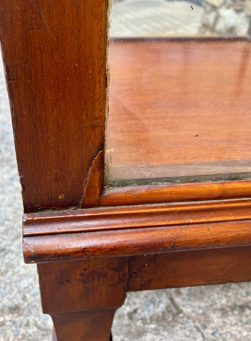 A tall, slim mahogany shop display cabinet featuring glass side panels, a single glazed door, three interior glass shelves, and brass catches. View XV