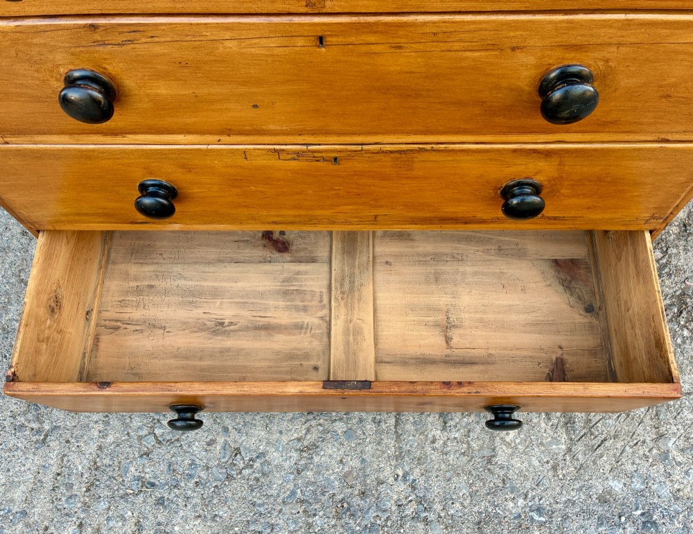 An antique warm pine chest of drawers featuring a two-over-three drawer arrangement with dark turned wooden knobs. View VIII