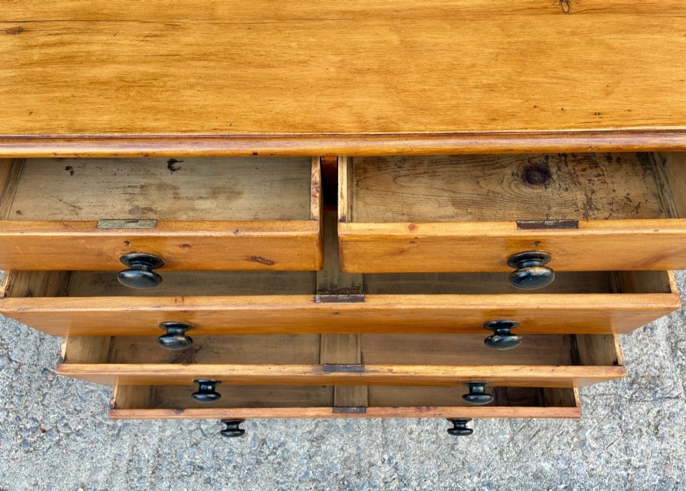 An antique warm pine chest of drawers featuring a two-over-three drawer arrangement with dark turned wooden knobs. View IX