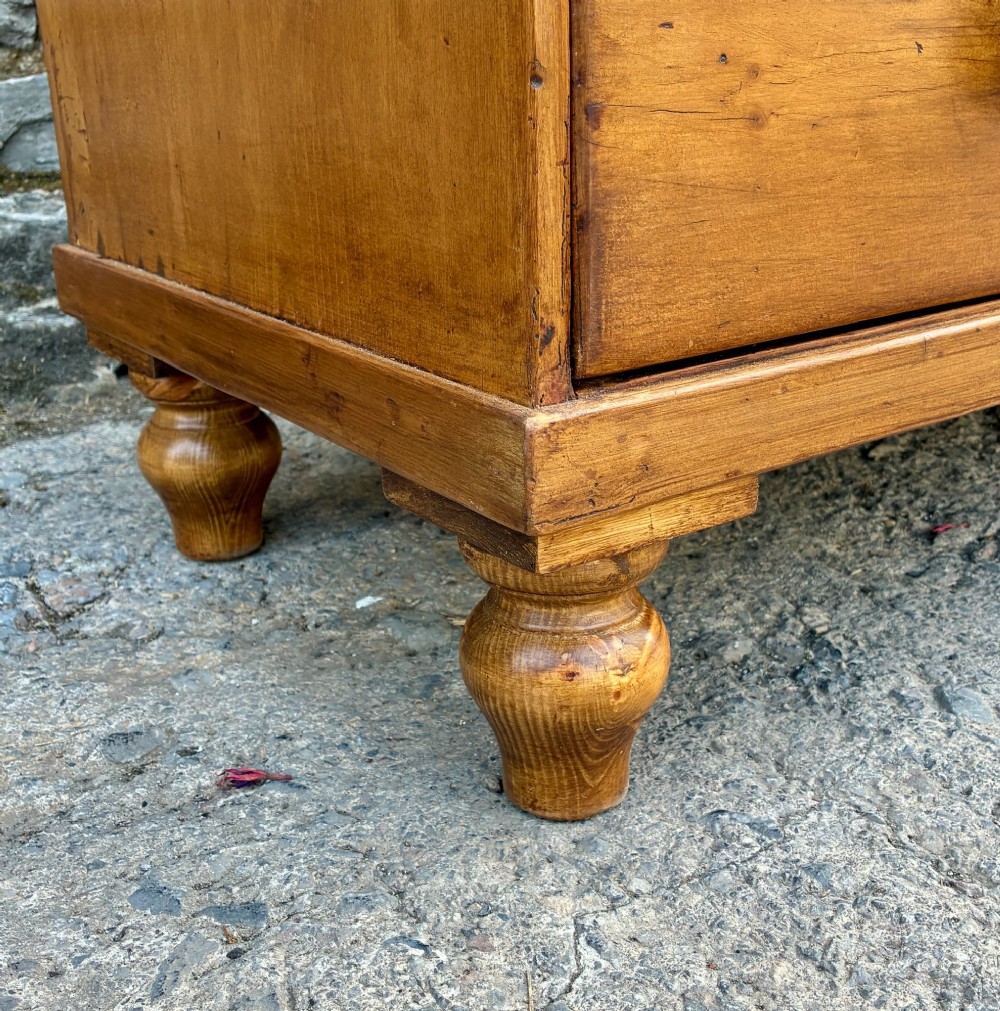 An antique warm pine chest of drawers featuring a two-over-three drawer arrangement with dark turned wooden knobs. View XI