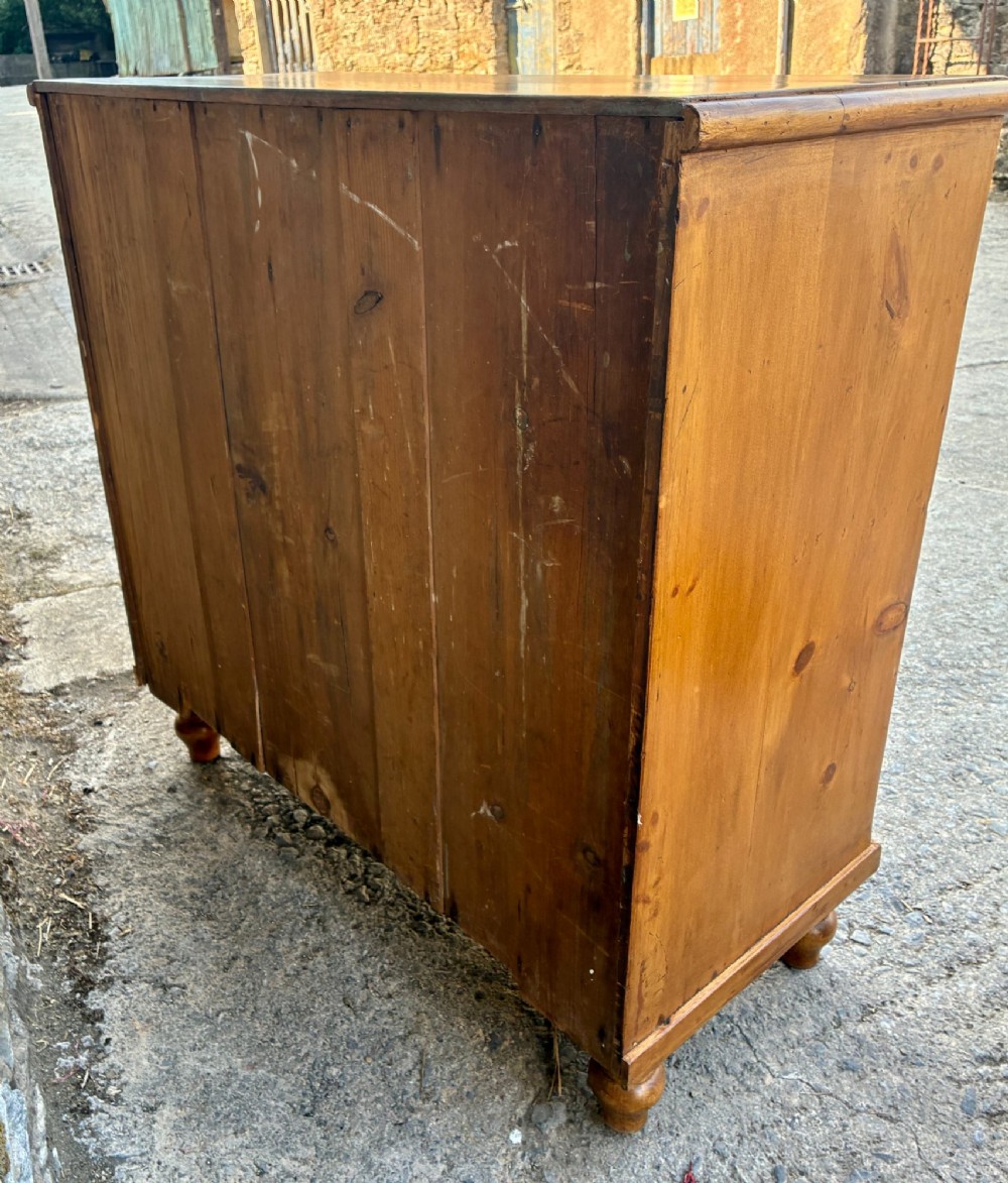 An antique warm pine chest of drawers featuring a two-over-three drawer arrangement with dark turned wooden knobs. View XIII