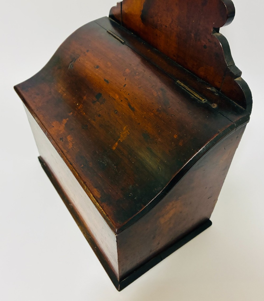 A dark mahogany Georgian hanging salt box with a curved hinged lid and a shaped backplate featuring a circular hanging hole. View III