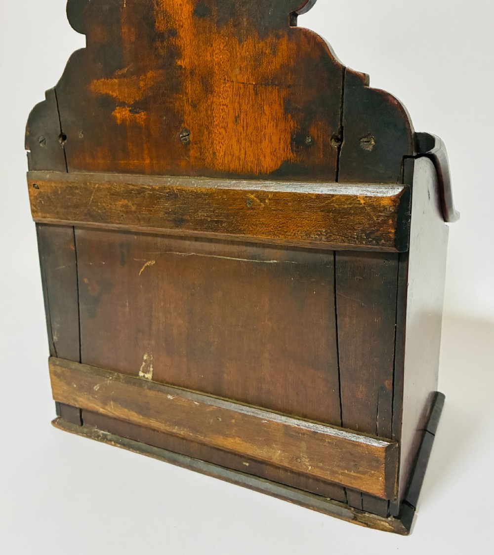 A dark mahogany Georgian hanging salt box with a curved hinged lid and a shaped backplate featuring a circular hanging hole. View VIII