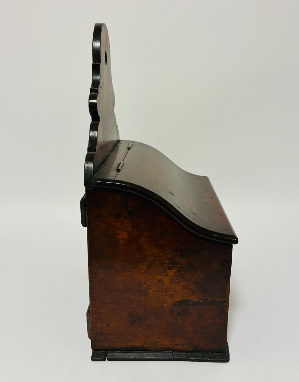 A dark mahogany Georgian hanging salt box with a curved hinged lid and a shaped backplate featuring a circular hanging hole. View IX