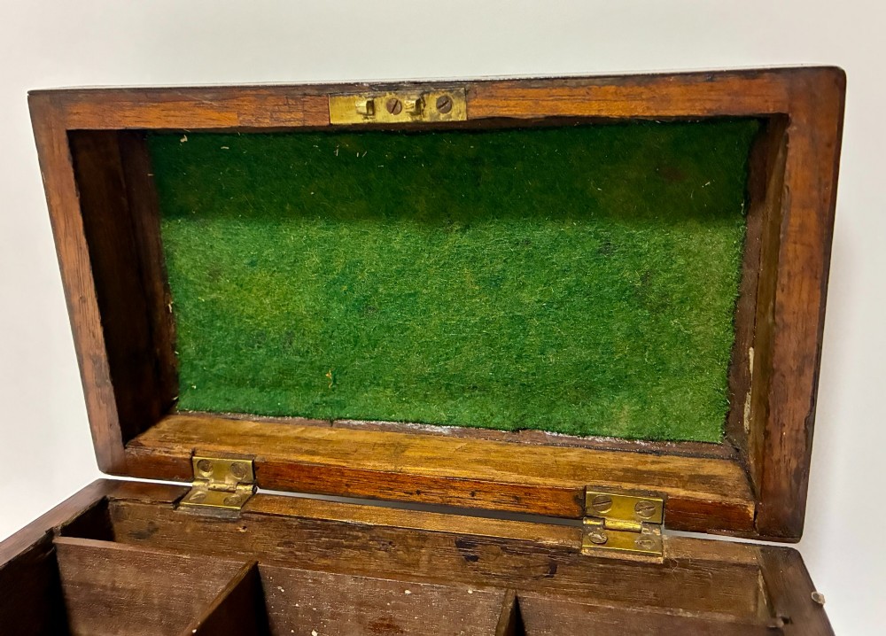 A rectangular George III mahogany tea caddy with a stepped lid, top brass swing handle, pierced brass escutcheon with key, and four brass claw-and-ball feet. View IV