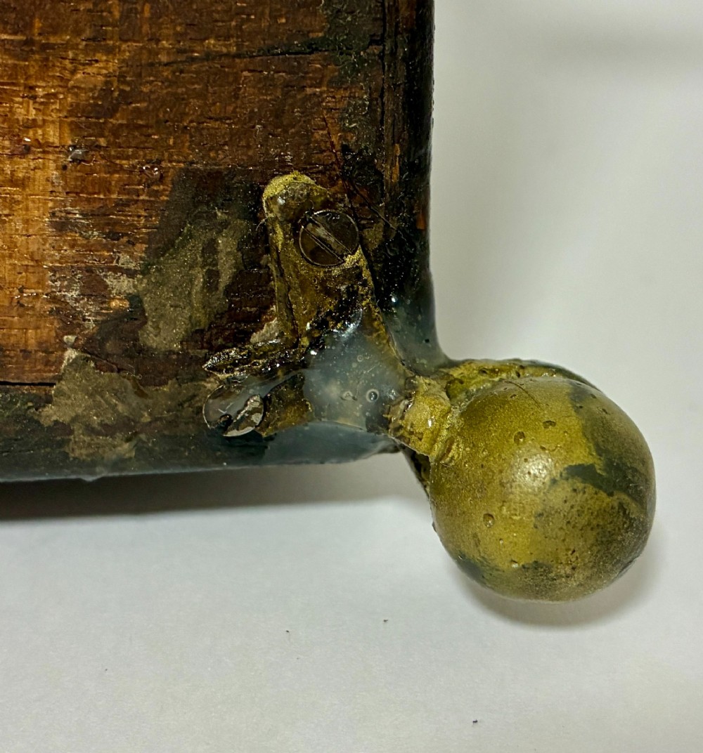 A rectangular George III mahogany tea caddy with a stepped lid, top brass swing handle, pierced brass escutcheon with key, and four brass claw-and-ball feet. View XV
