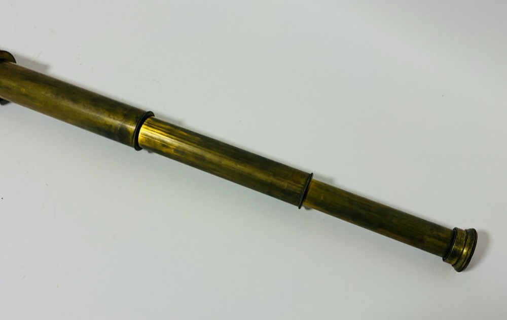 An extended three-draw antique brass pocket telescope featuring a dark brown textured leather barrel wrap. View VI