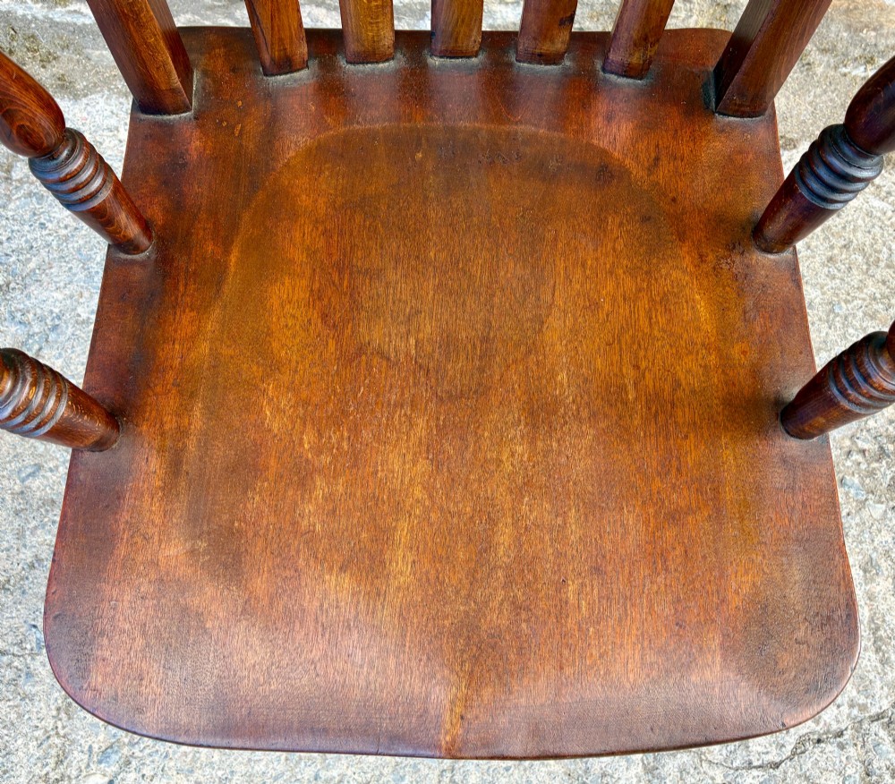 A Victorian country lath back armchair in warm brown wood, featuring vertical back slats, curved armrests, a contoured seat, and turned legs. View II