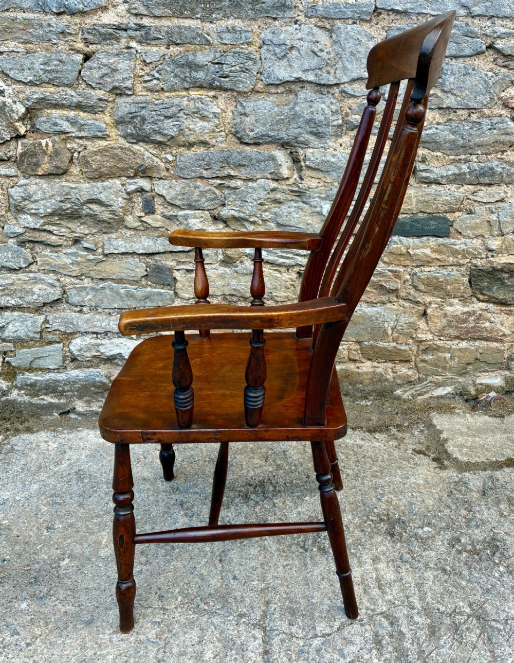 A Victorian country lath back armchair in warm brown wood, featuring vertical back slats, curved armrests, a contoured seat, and turned legs. View IV