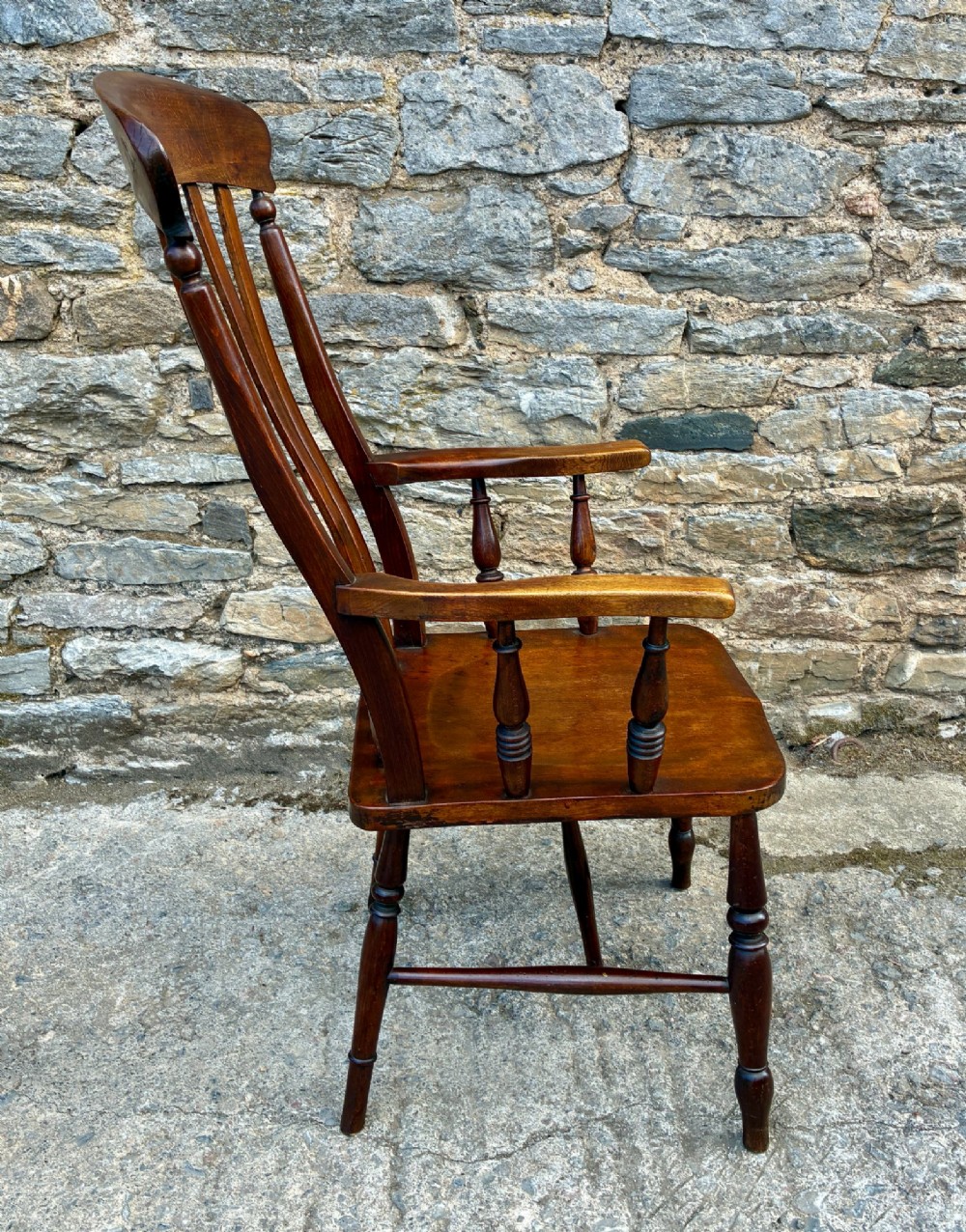 A Victorian country lath back armchair in warm brown wood, featuring vertical back slats, curved armrests, a contoured seat, and turned legs. View VIII