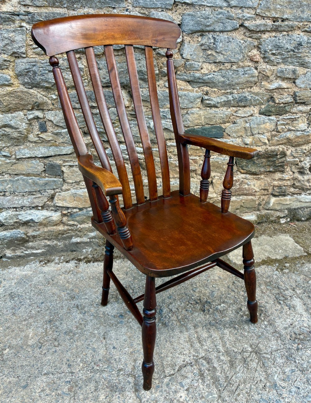 A Victorian country lath back armchair in warm brown wood, featuring vertical back slats, curved armrests, a contoured seat, and turned legs. View IX
