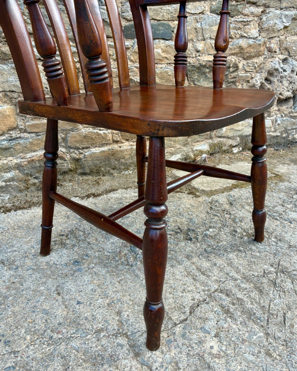 A Victorian country lath back armchair in warm brown wood, featuring vertical back slats, curved armrests, a contoured seat, and turned legs. View X