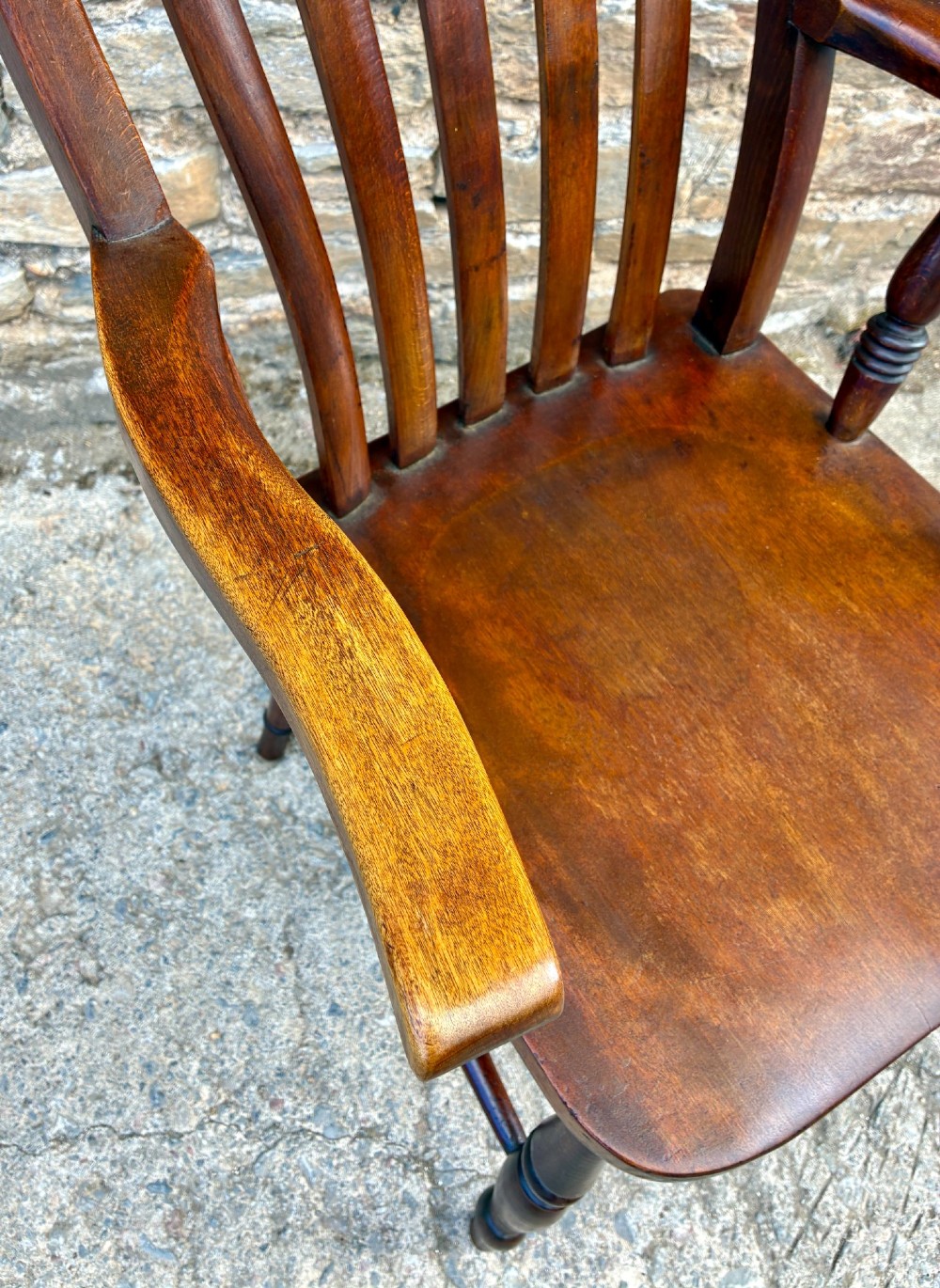 A Victorian country lath back armchair in warm brown wood, featuring vertical back slats, curved armrests, a contoured seat, and turned legs. View XII