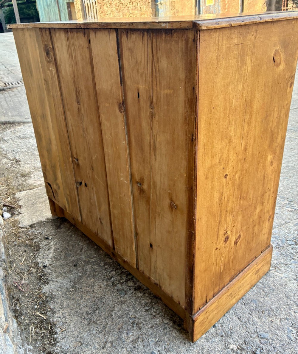 A Victorian pine chest of drawers featuring a two short over three long drawer arrangement with turned wooden knobs. View XII
