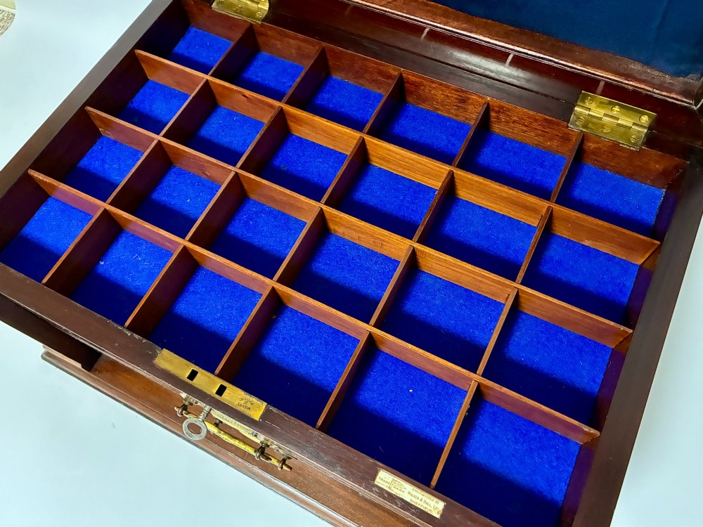 An Edwardian warm brown mahogany collectors box featuring wood inlay, brass drop handles, and a polished lid. View VII