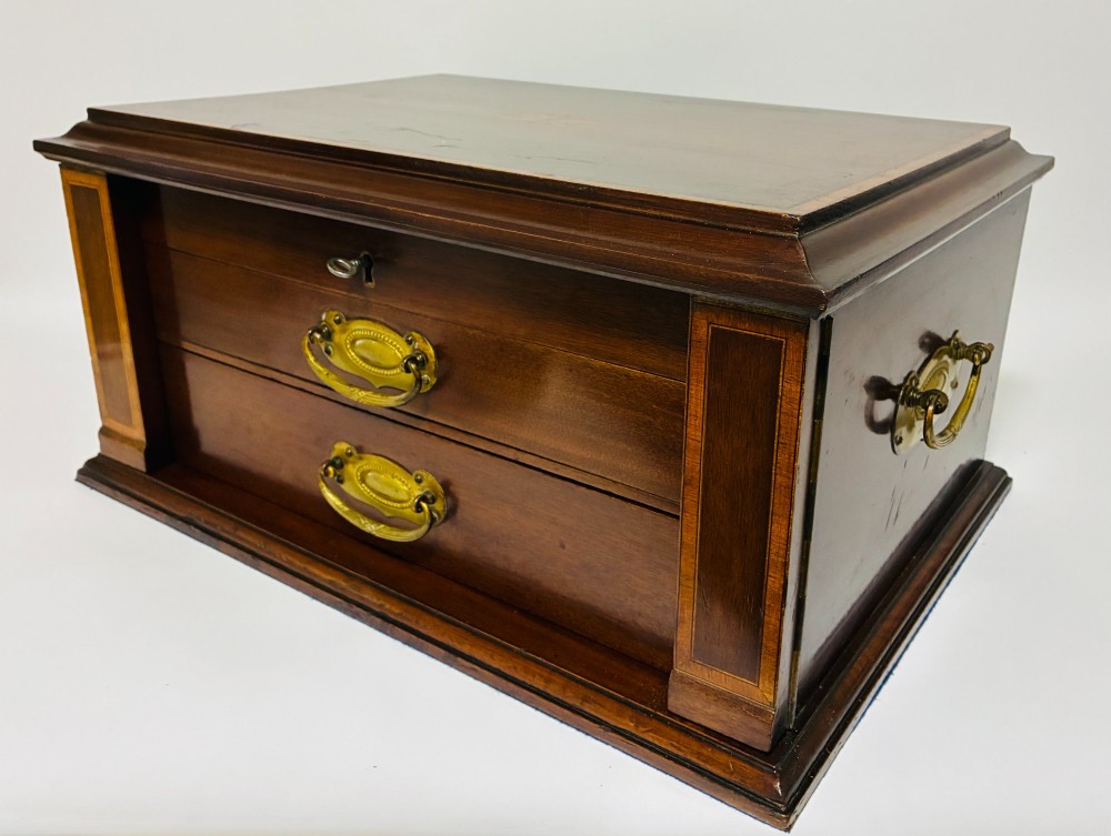 An Edwardian warm brown mahogany collectors box featuring wood inlay, brass drop handles, and a polished lid. View VIII
