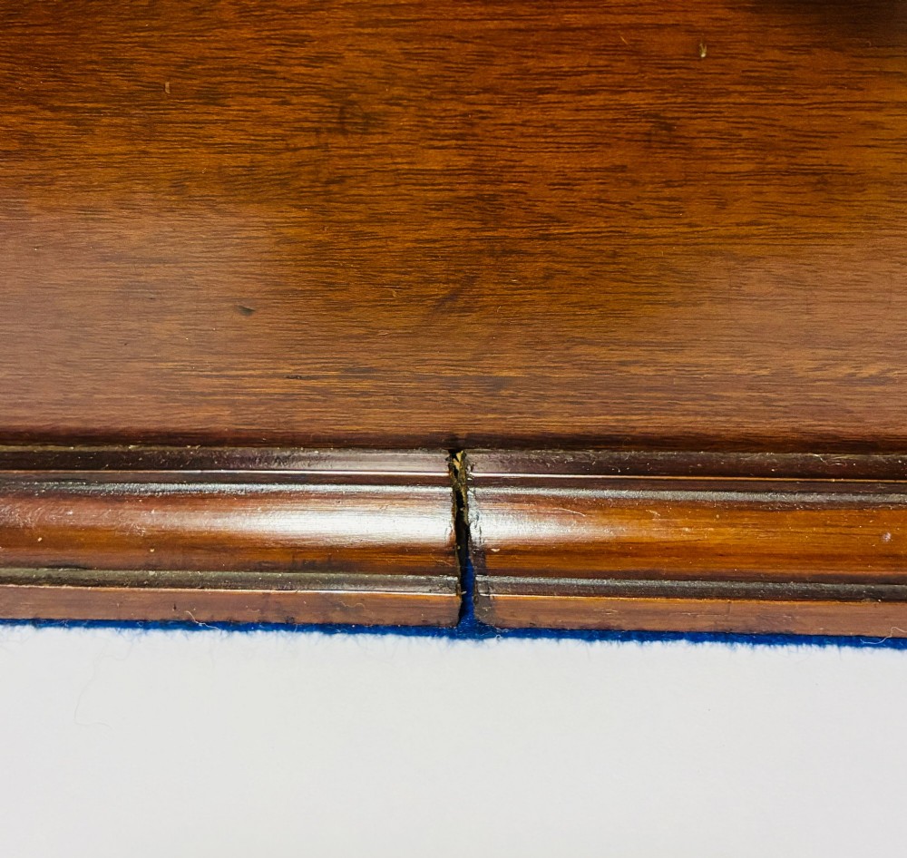 An Edwardian warm brown mahogany collectors box featuring wood inlay, brass drop handles, and a polished lid. View XII