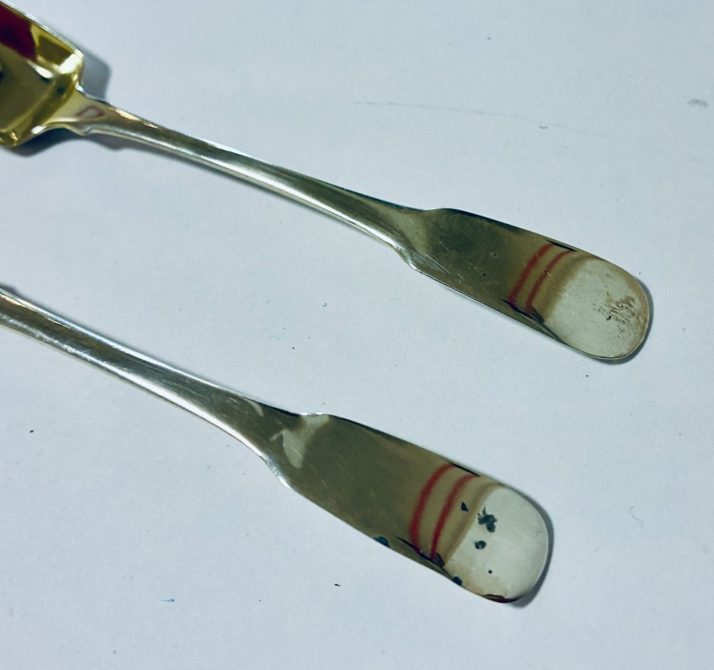 A pair of Georgian silver salt shovels featuring rectangular silver-gilt shovel bowls and smooth fiddle pattern handles. View III