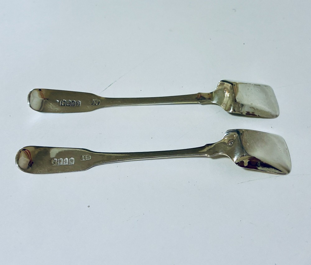 A pair of Georgian silver salt shovels featuring rectangular silver-gilt shovel bowls and smooth fiddle pattern handles. View VI