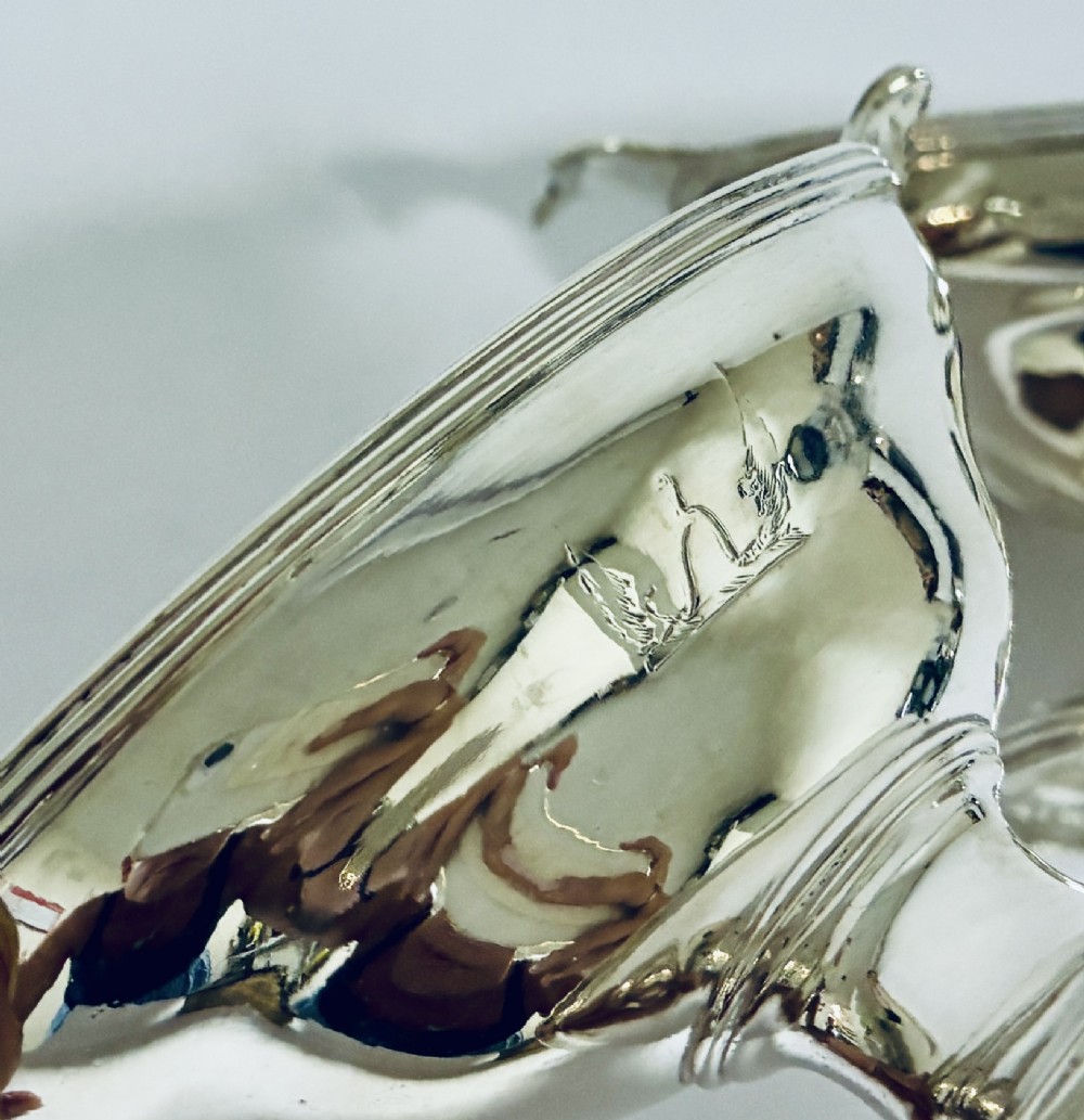 A pair of Georgian sterling silver boat-shaped salt cellars with pedestal bases and gilded interiors. View V