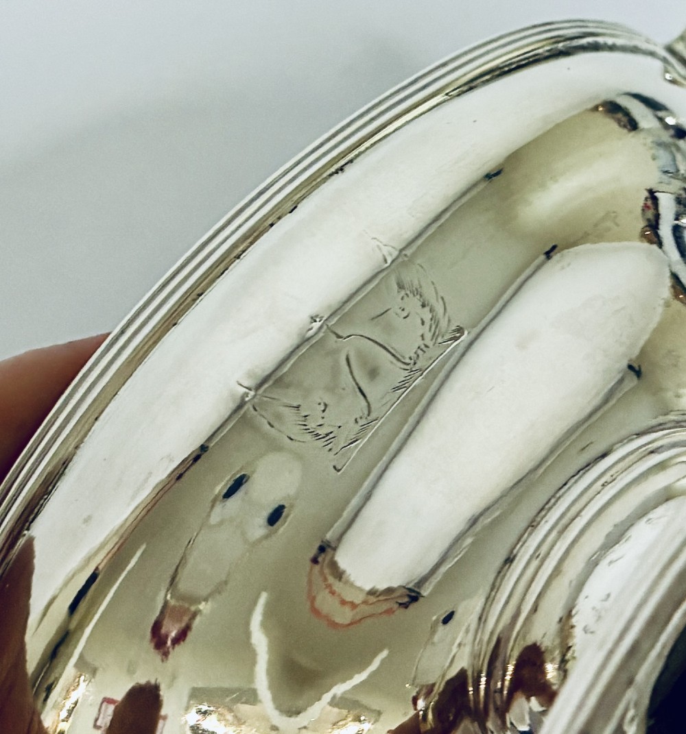 A pair of Georgian sterling silver boat-shaped salt cellars with pedestal bases and gilded interiors. View VI