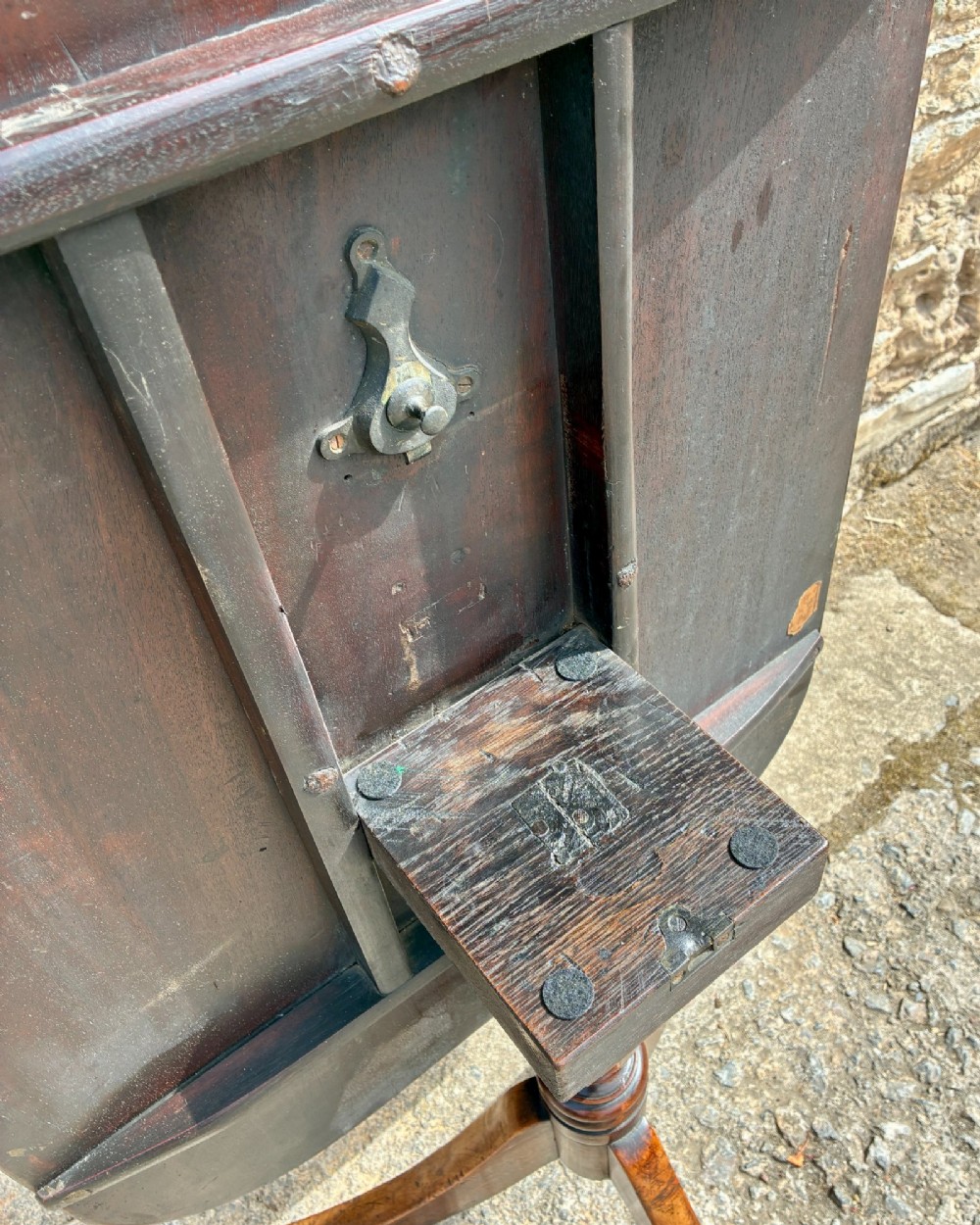 A Victorian mahogany tilt-top table featuring a polished rounded rectangular surface set on a turned pedestal column with three splayed legs. View XI
