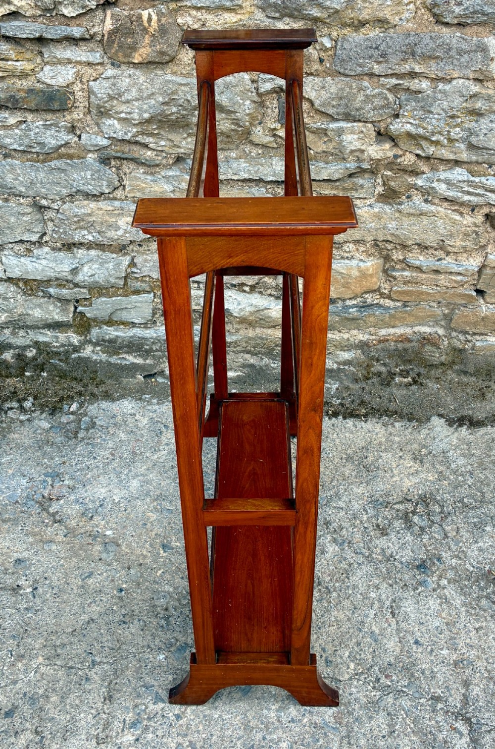 An Edwardian mahogany freestanding towel rail featuring double horizontal bars, a lower solid wooden shelf, vertical side supports, and flared feet. View III