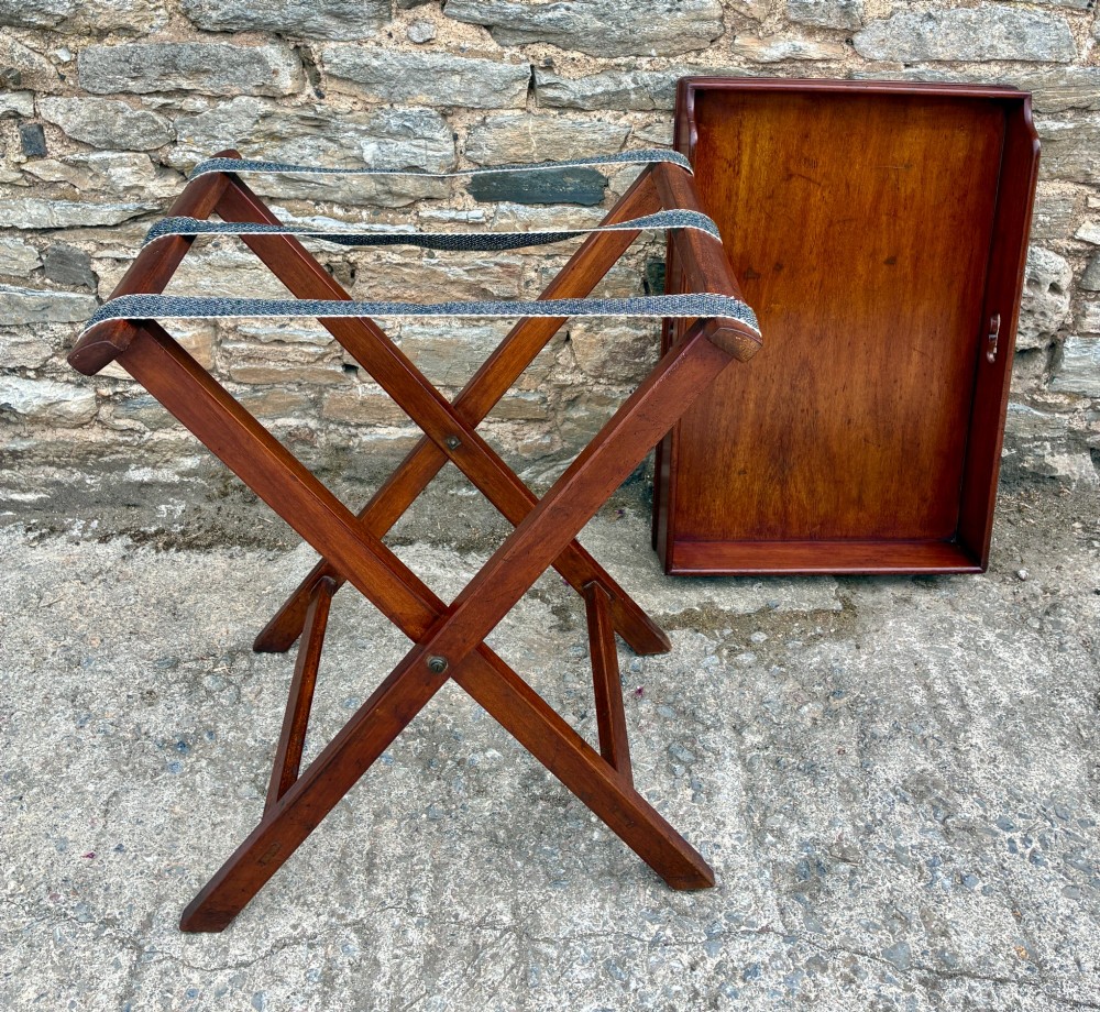 A Victorian mahogany butlers tray with cut-out hand holes resting on a folding wooden X-frame stand. View IX