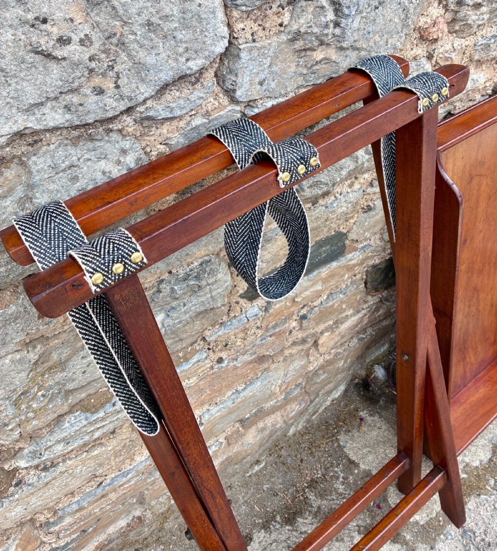 A Victorian mahogany butlers tray with cut-out hand holes resting on a folding wooden X-frame stand. View XI