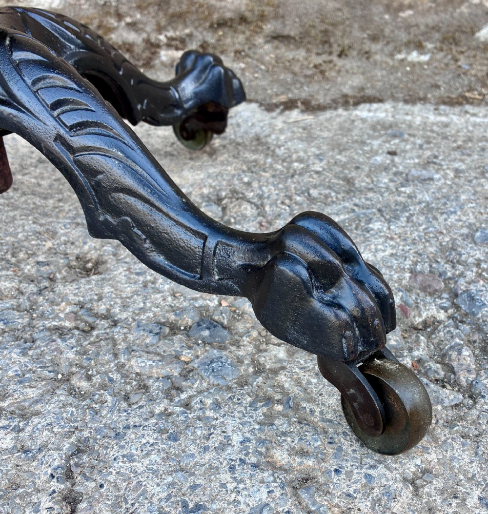 Victorian adjustable display stand featuring a round mahogany top, a brass telescoping stem, and a black cast iron paw-foot base. View IV