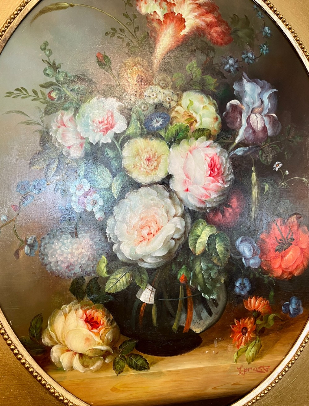 A pair of oil paintings on board featuring floral bouquets framed within oval apertures inside ornate gold frames. View IV